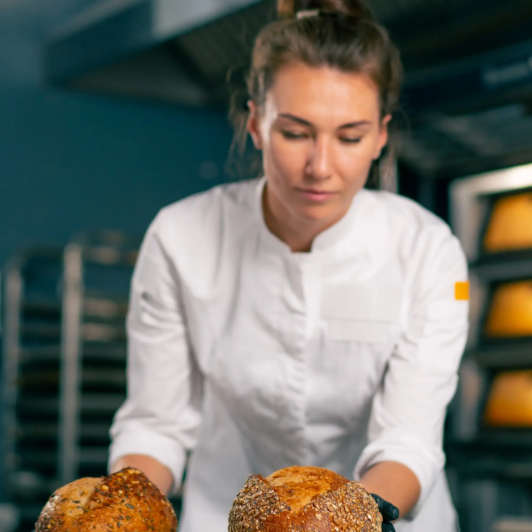 Dominika Zawadzka preparing artisan bread in a professional kitchen at SliceSync.