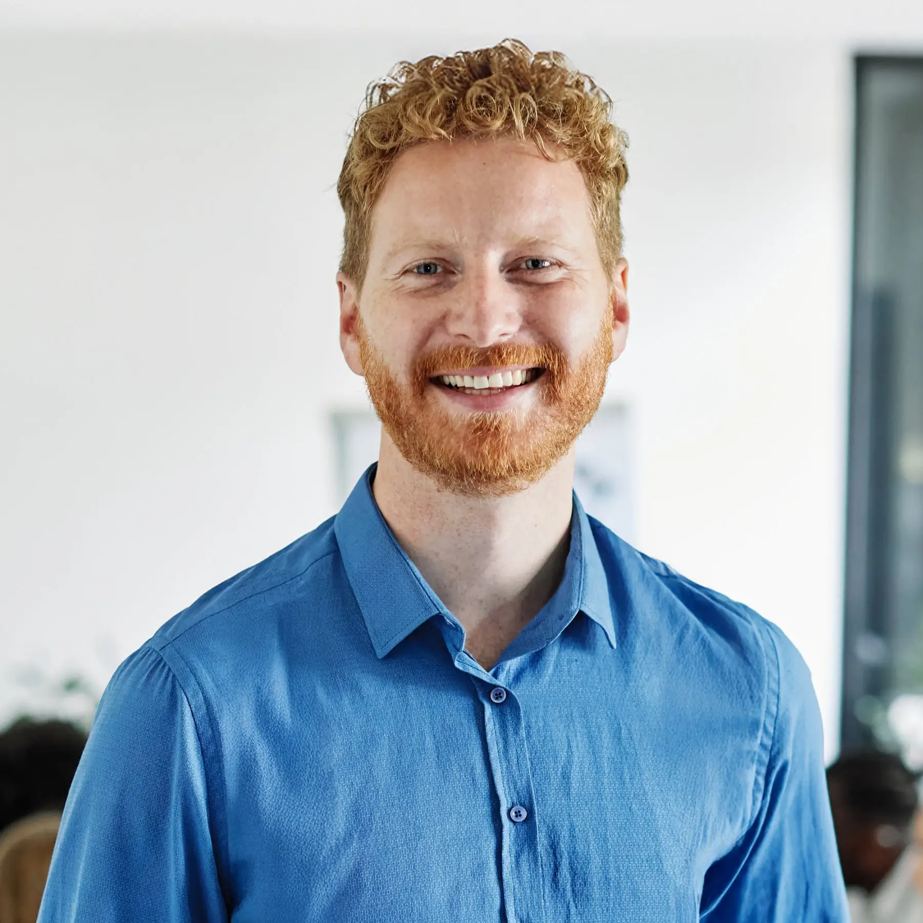Portrait of Lucas Meyer, Recipe Development Assistant at SliceSync, smiling in a bright indoor setting.