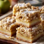 Easy Apple Pie Bars for Summer Parties 2 Apple Pie Bars with crumb crust, spiced apple filling, and golden topping on a tray