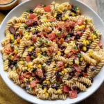 Cowboy Caviar Pasta Salad with rotini pasta, black beans, corn, tomatoes, and crispy bacon