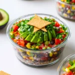 Cowboy Caviar Salad for Meal Prep with avocado, black beans, corn, tomatoes, and cilantro in glass bowls