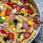 Easy Italian Pasta Salad with rotini pasta, salami, tomatoes, olives, and mozzarella