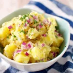Easy No Mayo Potato Salad with red onions, herbs, and tender potatoes in a serving bowl