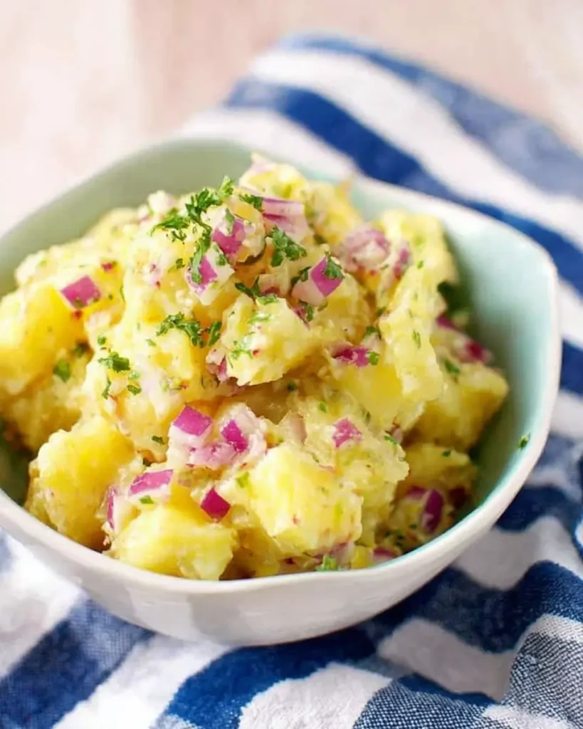 Easy No Mayo Potato Salad with red onions, herbs, and tender potatoes in a serving bowl