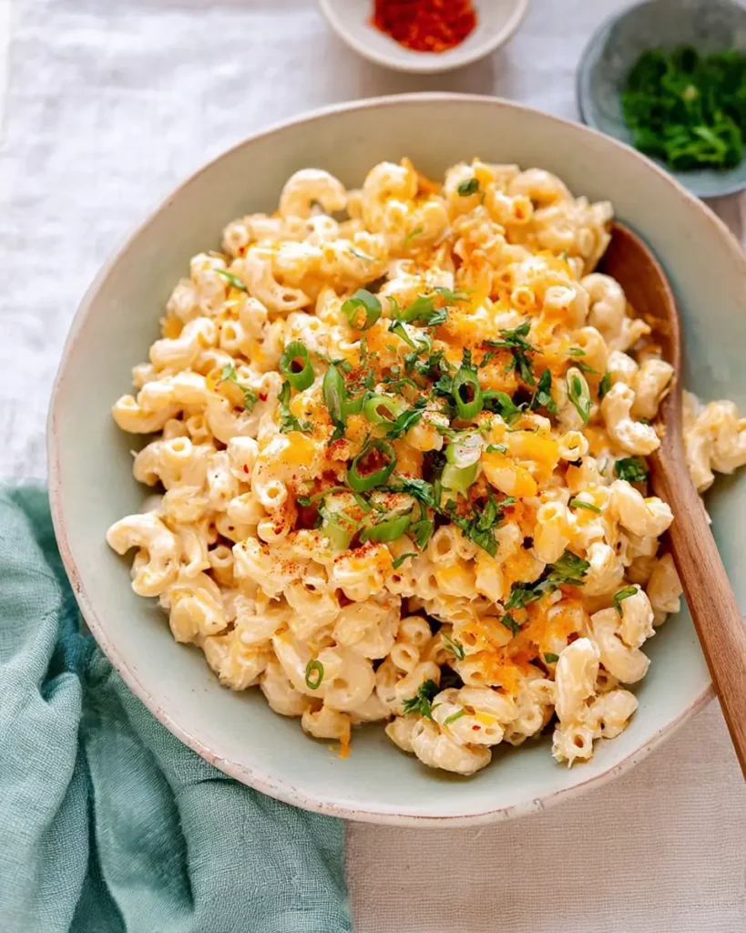 Hawaiian Macaroni Salad in a bowl topped with green onions and paprika seasoning