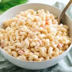 Macaroni Salad for a Crowd served in a large bowl with creamy dressing and elbow macaroni