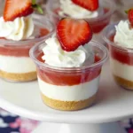 No-Bake Strawberry Cheesecake Cups layered with cheesecake filling, strawberry topping, and whipped cream