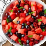 Watermelon Fruit Salad with berries, grapes, and fresh mint leaves